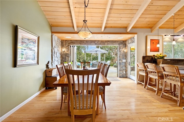 dining room with wood ceiling, light hardwood / wood-style flooring, and beamed ceiling