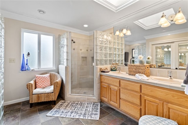 bathroom featuring crown molding, a skylight, vanity, and an enclosed shower