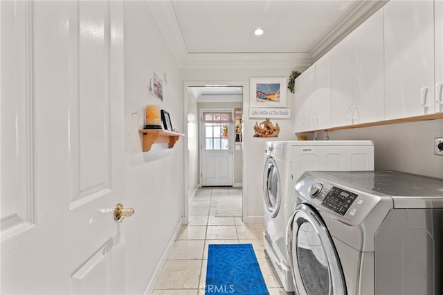 laundry area featuring independent washer and dryer, ornamental molding, and cabinets