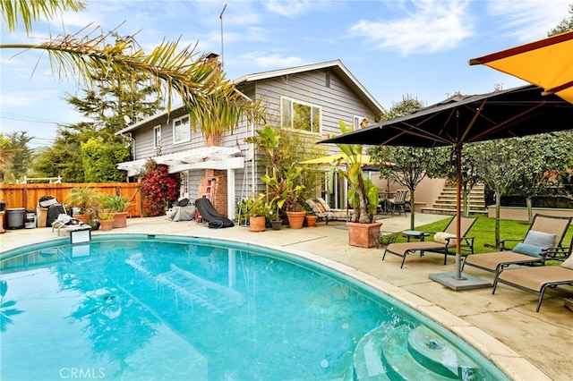 view of swimming pool featuring a fenced in pool, a patio area, and fence