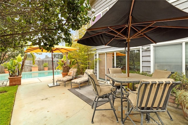 view of patio featuring a fenced backyard, a fenced in pool, and outdoor dining space