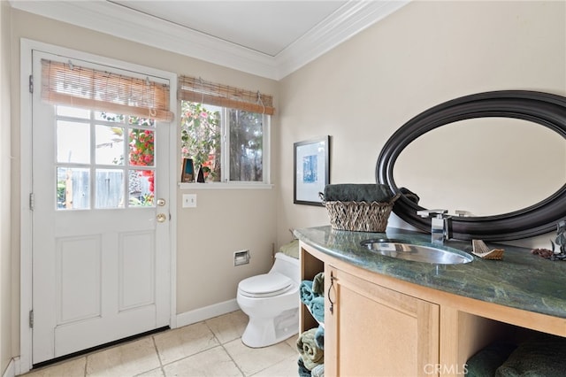 bathroom featuring toilet, baseboards, tile patterned flooring, vanity, and ornamental molding