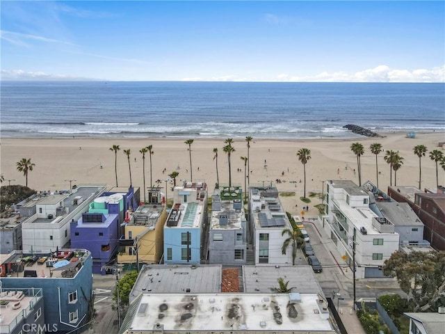 drone / aerial view featuring a water view and a beach view