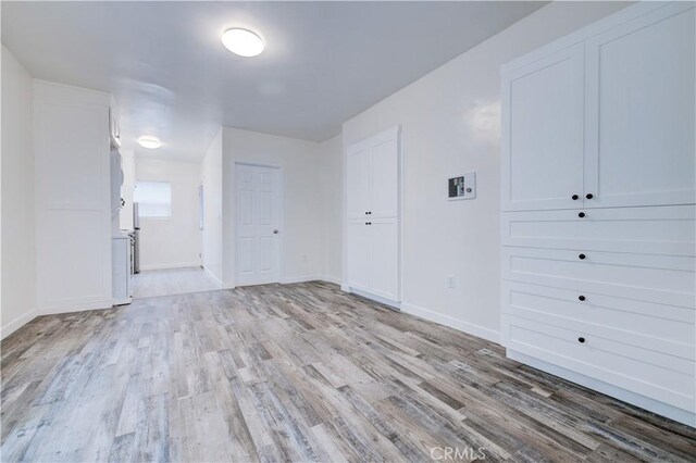 spare room featuring light hardwood / wood-style flooring