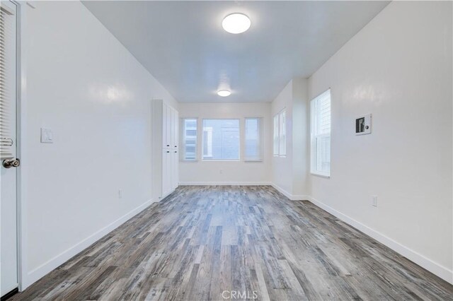 unfurnished room with wood-type flooring