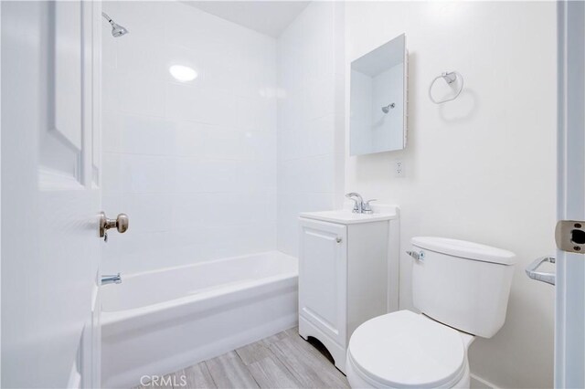 full bathroom with hardwood / wood-style flooring, vanity, toilet, and  shower combination