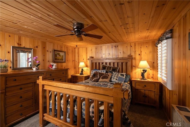 carpeted bedroom with wood ceiling and wooden walls