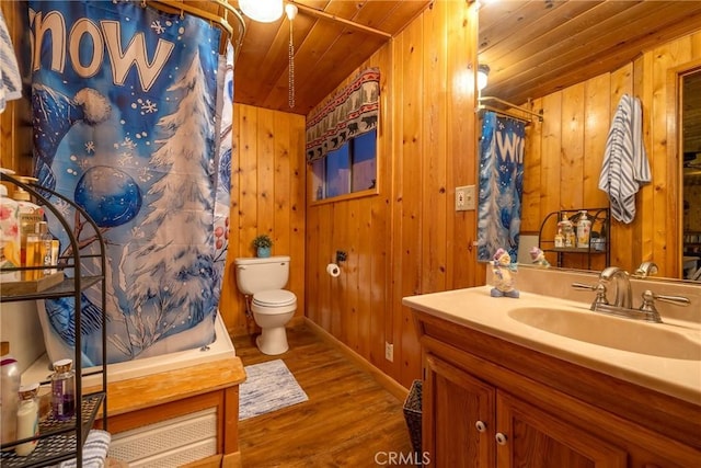 bathroom featuring wooden walls, hardwood / wood-style flooring, vanity, wood ceiling, and toilet