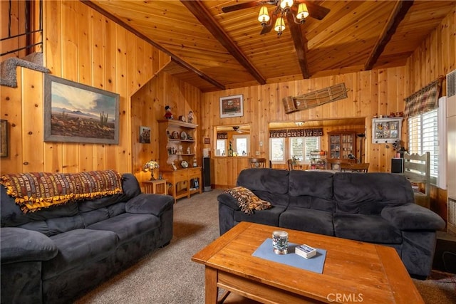 living room with wood walls, wooden ceiling, carpet floors, ceiling fan, and beam ceiling