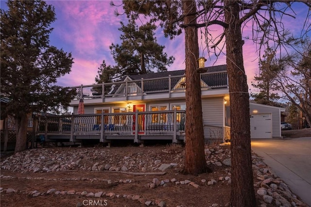 back house at dusk with a deck