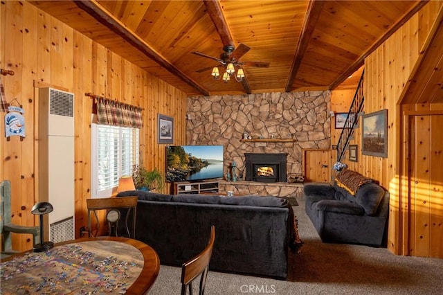 carpeted living room with wood ceiling, a fireplace, beamed ceiling, and wood walls