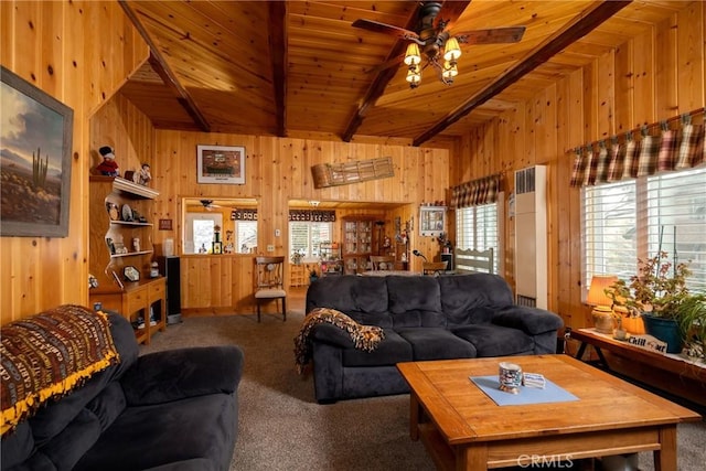 carpeted living room with vaulted ceiling with beams, wood ceiling, ceiling fan, and wood walls