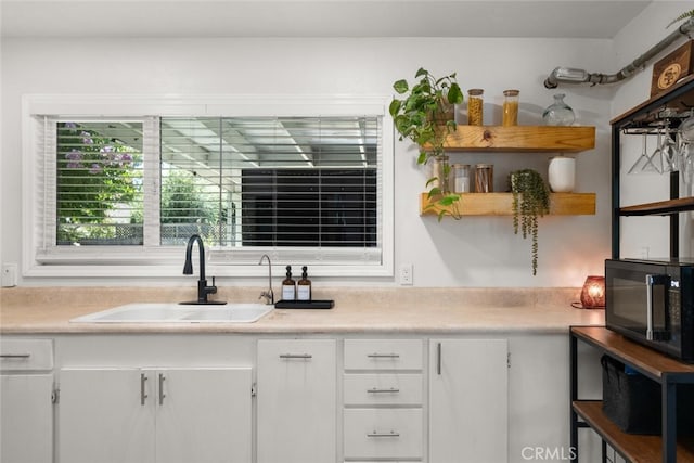 bar featuring white cabinetry and sink