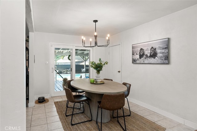 dining area featuring light tile patterned flooring and an inviting chandelier