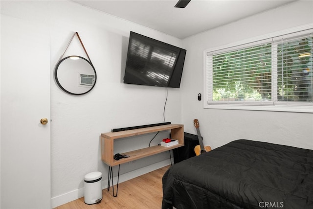 bedroom with ceiling fan and light wood-type flooring