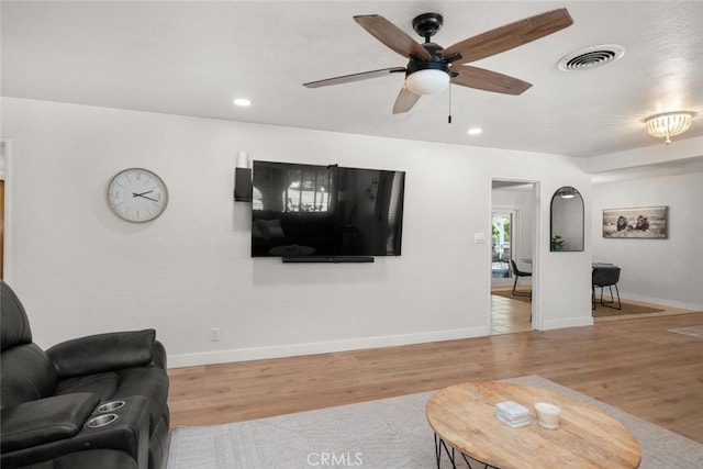 living room with ceiling fan and hardwood / wood-style floors