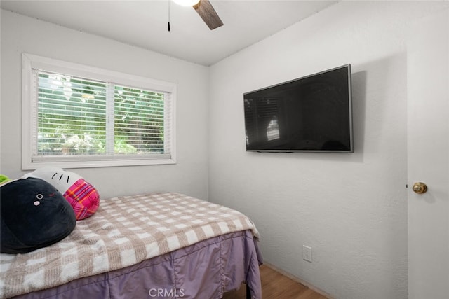 bedroom with hardwood / wood-style flooring and ceiling fan