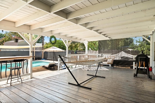 wooden terrace featuring a fenced in pool