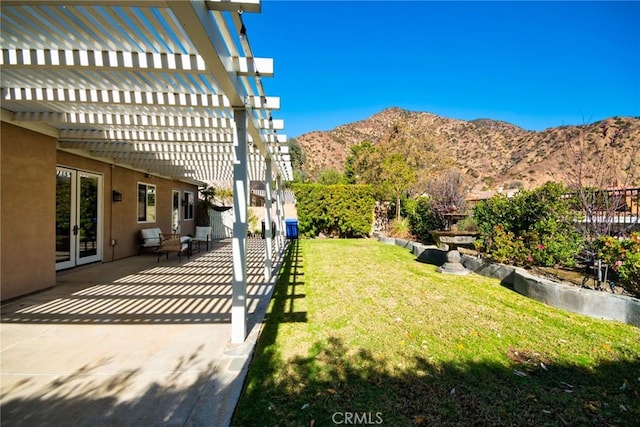 view of yard with a mountain view, a pergola, and a patio