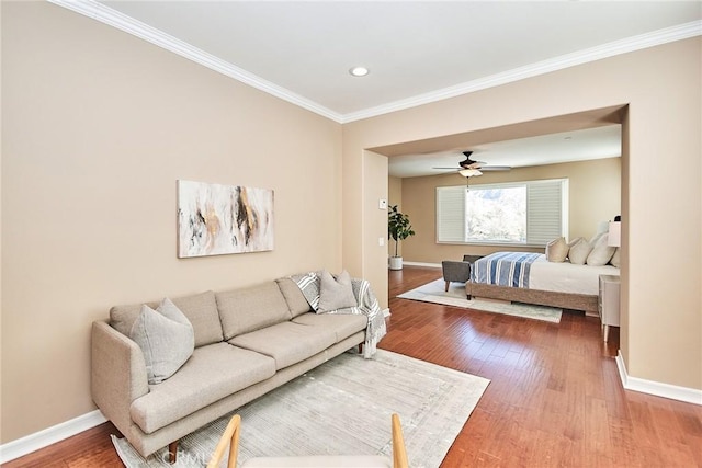 bedroom with crown molding, ceiling fan, and hardwood / wood-style floors