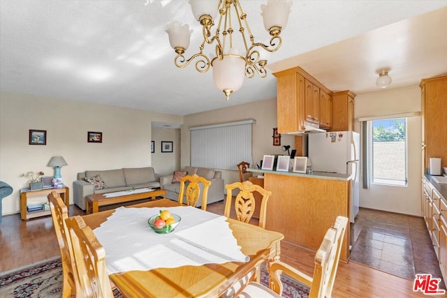 dining room featuring hardwood / wood-style floors and a notable chandelier