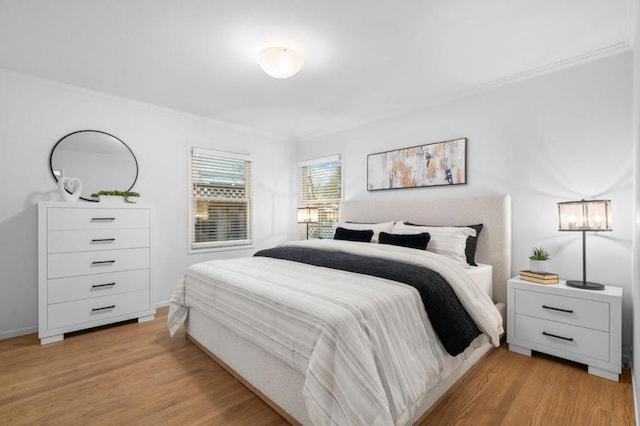 bedroom featuring light hardwood / wood-style flooring and ornamental molding