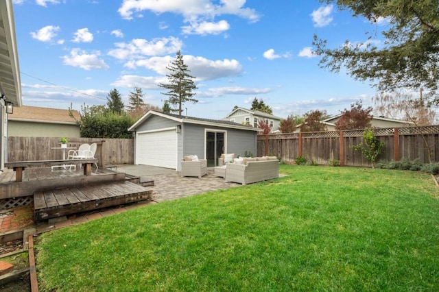 view of yard with an outbuilding, a garage, outdoor lounge area, and a wooden deck