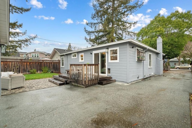 back of property featuring a patio and a deck