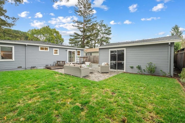 rear view of house featuring an outdoor living space, a patio area, and a lawn