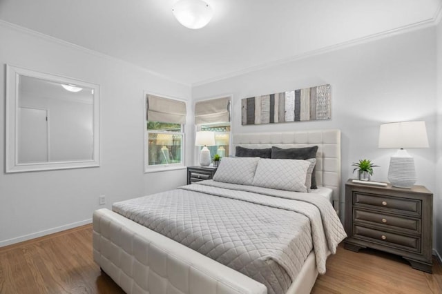 bedroom featuring hardwood / wood-style flooring and ornamental molding