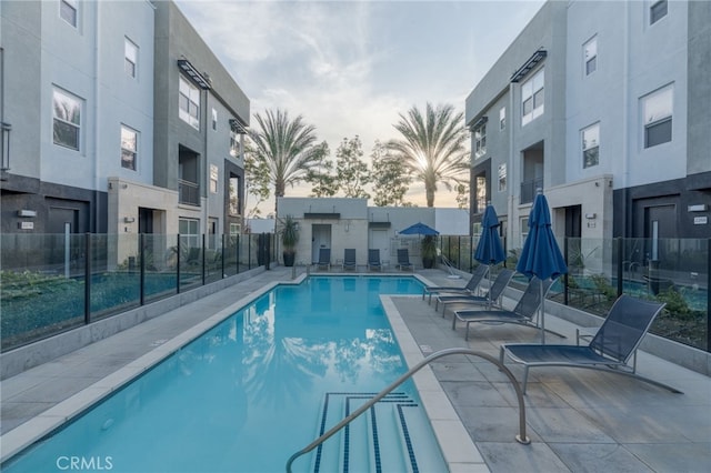 pool at dusk with a patio