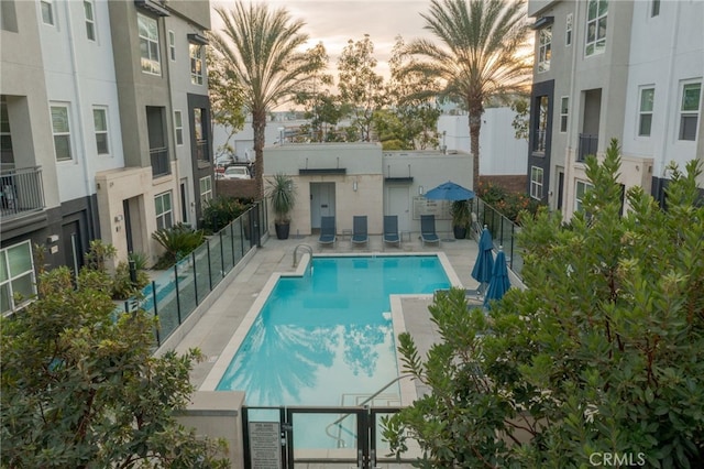 view of pool at dusk