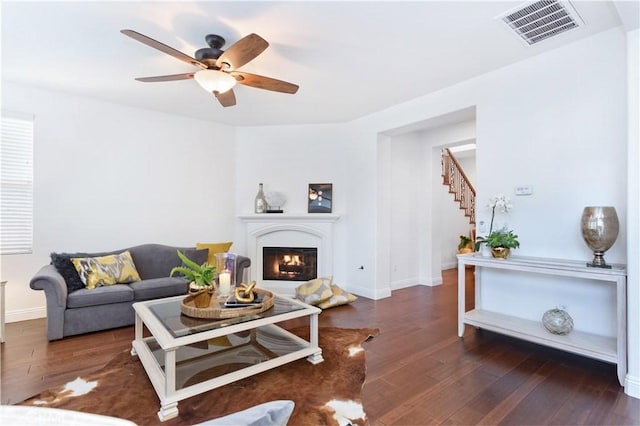 living room with dark hardwood / wood-style floors and ceiling fan