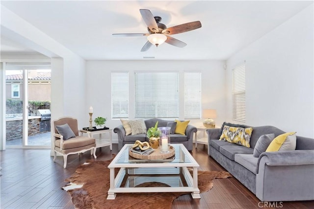 living area with wood finished floors and a ceiling fan