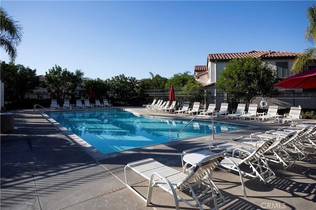 pool featuring a patio area and fence