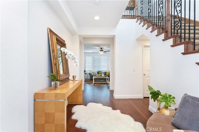 foyer with recessed lighting, wood finished floors, a ceiling fan, baseboards, and stairway