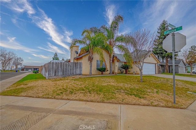 view of front of home with a garage and a front lawn