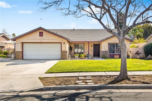 view of front of property with a garage and a front lawn