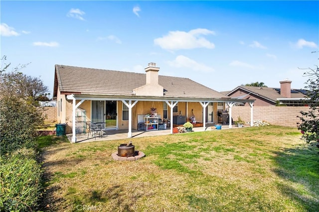 rear view of house with a lawn, cooling unit, and a patio area