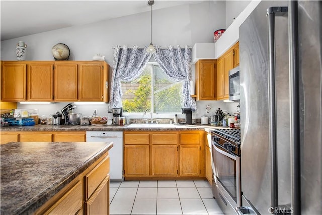 kitchen with stainless steel appliances, pendant lighting, sink, and light tile patterned floors