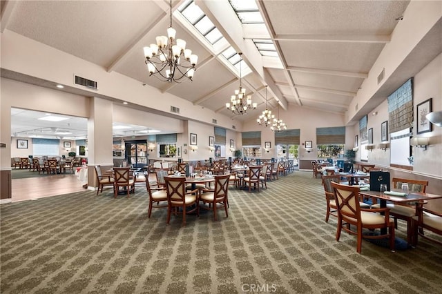 carpeted dining room featuring beam ceiling, high vaulted ceiling, a wealth of natural light, and a chandelier