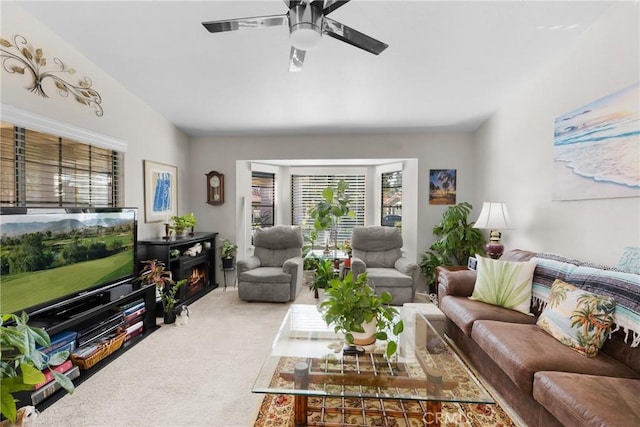 carpeted living room featuring ceiling fan