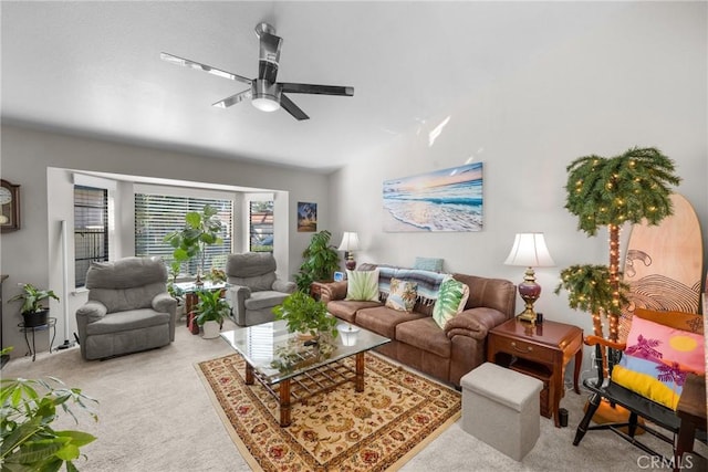 carpeted living room with ceiling fan