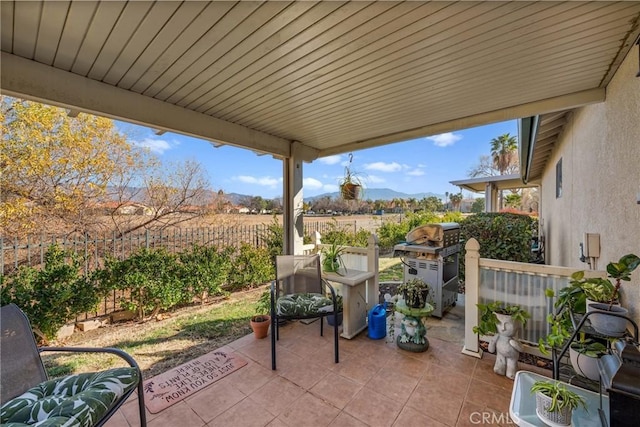 view of patio / terrace with a mountain view, a rural view, and grilling area