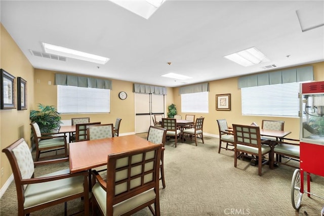 dining room with light colored carpet