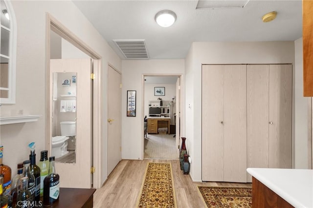 corridor featuring light hardwood / wood-style floors