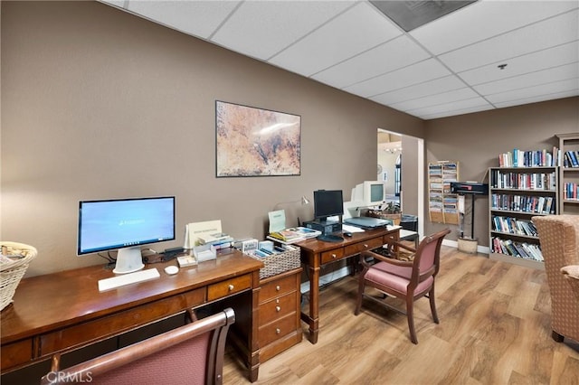 office area with a drop ceiling and light hardwood / wood-style flooring