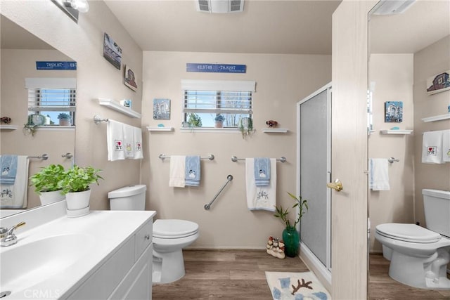 bathroom with vanity, hardwood / wood-style flooring, plenty of natural light, and toilet