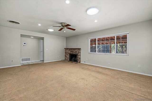 unfurnished living room with ceiling fan, carpet flooring, and a fireplace