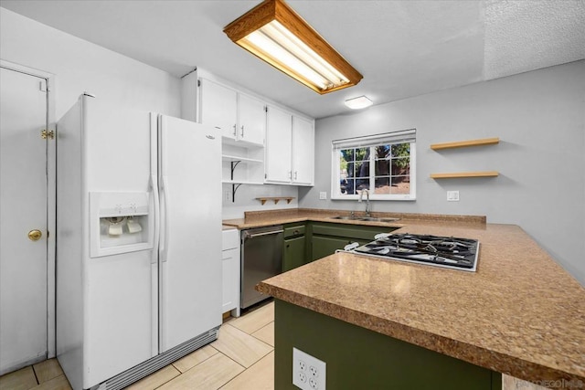 kitchen featuring stainless steel appliances, white cabinets, and kitchen peninsula